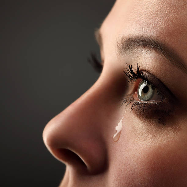 Teardrop falling from woman's eye beauty girl cry teardrop stock pictures, royalty-free photos & images
