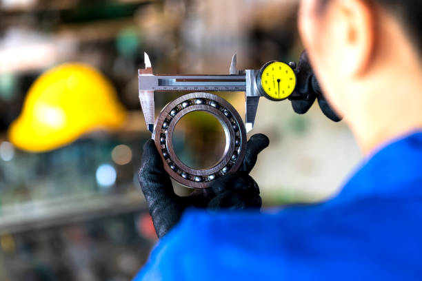 Technician measuring ball bearing by vernier caliper tools stock photo