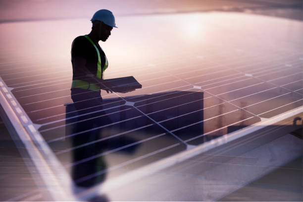 Technician standing on roof checking Photovoltaic cells panels on factory, Maintenance of the solar panels, Engineer service, Inspector concept. Double Exposure Photo. stock photo