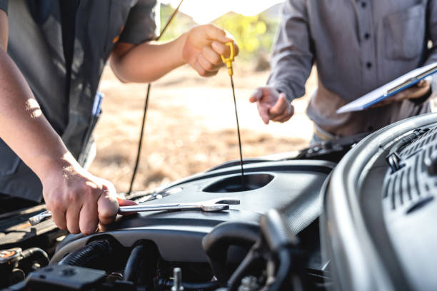 Technician team working of car mechanic in doing auto repair service and maintenance worker repairing vehicle with checking oil, Service and Maintenance car check stock photo
