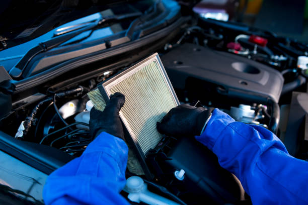 Technician uses hands checking air filter of car mechanic in auto repairing service. Service and Maintenance car. stock photo
