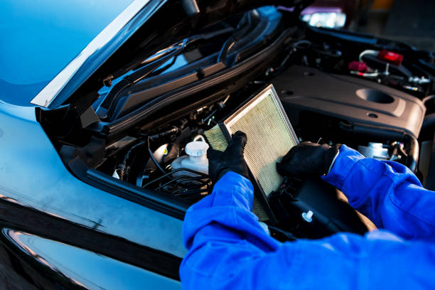 Technician uses hands checking air filter of car mechanic in auto repairing service. Service and Maintenance car. stock photo