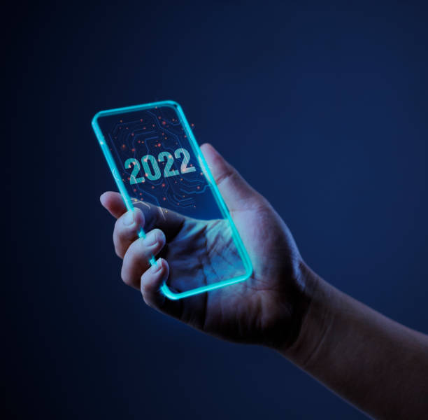 technology 2022 with mobile phone. Isolated on dark background. stock photo