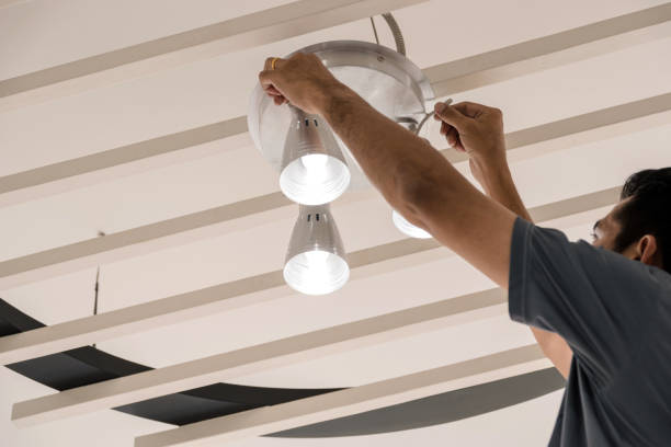 Technology in home Electrical engineers are installing ceiling lamps in the hallway. halogen light stock pictures, royalty-free photos & images