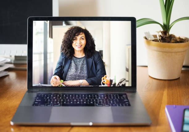 Technology makes business communication easier Shot of a mid adult businesswoman having a video call on a laptop job interview stock pictures, royalty-free photos & images