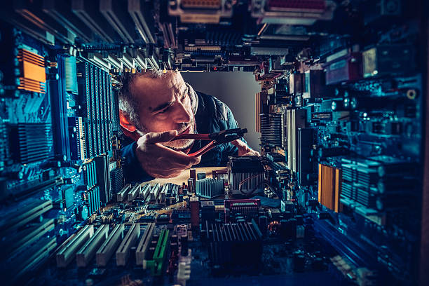 Technology Versus Man Technology versus man. Mid adult man repairing computer component, motherboard. Concept. mother board stock pictures, royalty-free photos & images
