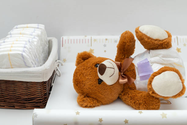 Teddy bear and diapers stock photo