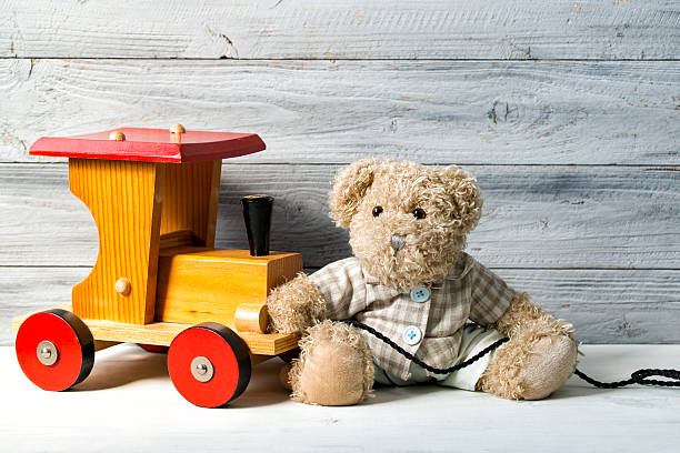 teddy bear and the toy wooden train, wooden background - teddy ray stok fotoğraflar ve resimler