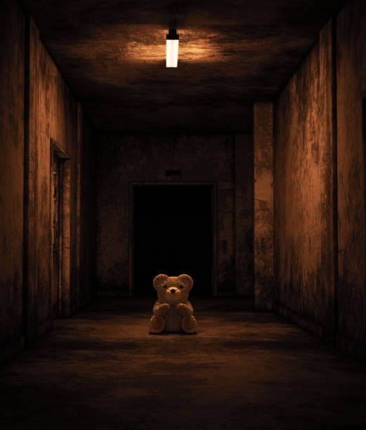 Teddy bear sitting in haunted house stock photo