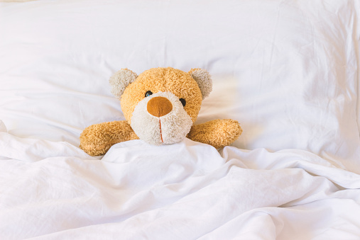Teddy Bear Sleeping On The Bed Stock Photo - Download Image Now - iStock