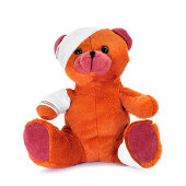 a teddy bear with bandages in its head, arm and leg, on a white background
