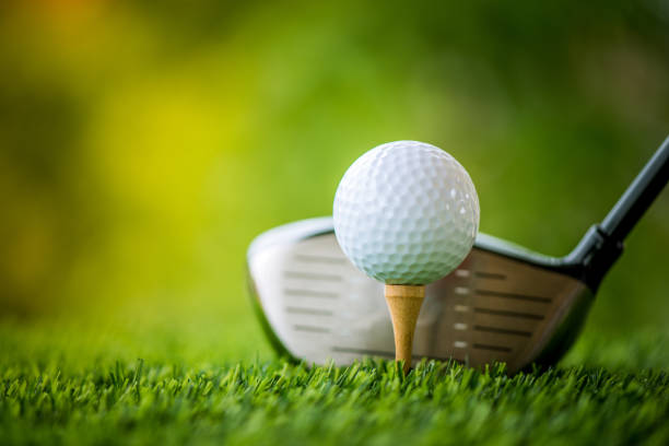 teeing off with golf club and golf ball stock photo