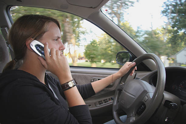 Teen Driver Talks on Cell Phone stock photo