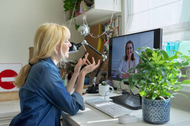 Teen girl talking online with psychologist, social worker stock photo