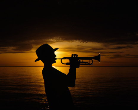 Teen Trumpet On The Beach At Sunset Stock Photo - Download Image Now -  iStock
