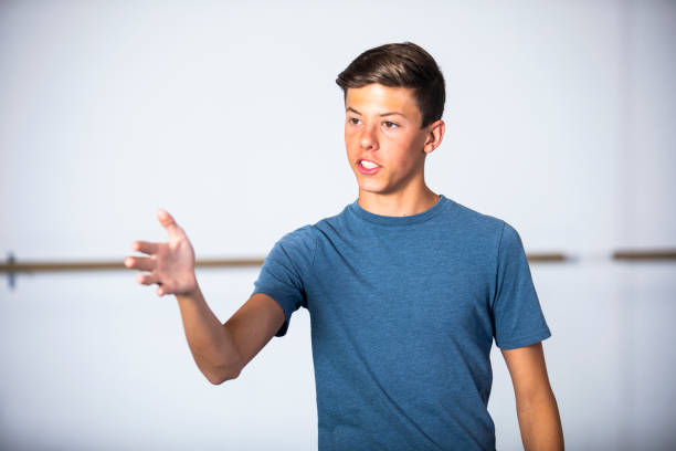 Teenage Boy Actor Practicing Theatre A young boy practicing his part for a drama performance young male actors stock pictures, royalty-free photos & images