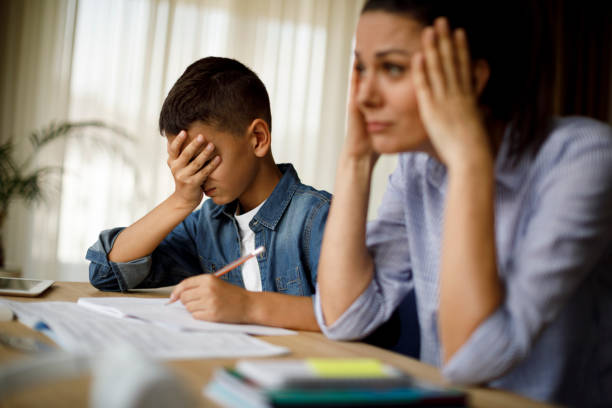 Teenage boy having problems in finishing homework Teenage boy having problems in finishing homework mother and teenage son stock pictures, royalty-free photos & images