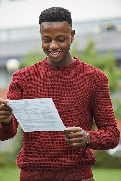 Teenage Boy Pleased With Good Exam Results Teenage Boy Pleased With Good Exam Results students exam results stock pictures, royalty-free photos & images