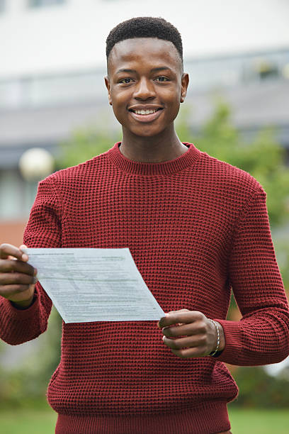 Teenage Boy Pleased With Good Exam Results Teenage Boy Pleased With Good Exam Results students exam results stock pictures, royalty-free photos & images