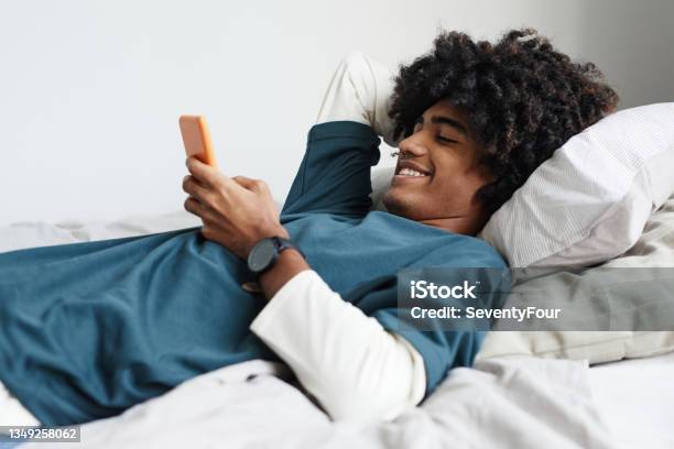 Teenage Boy Relaxing on Bed