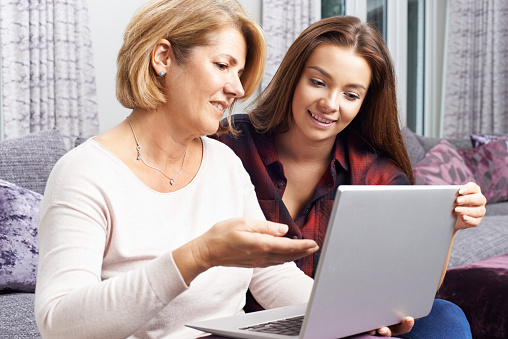 Mother And Daughter Using A Computer Stock Photo - Image 