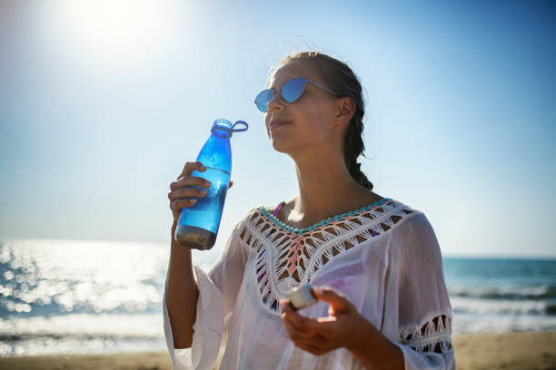 Teenage girl on beach drinking from reusable water bottle. Teenage girl on beach on a hot summer day. The girl is drinking cold water from a modern, reusable water bottle.
Nikon D850 reusable water bottle stock pictures, royalty-free photos & images