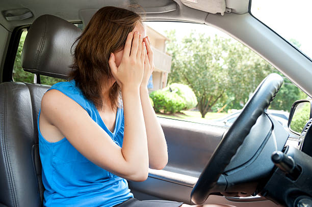 Teenage girl panic in car with hands cover her stock photo