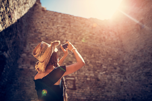Teenage girl sightseeing italian castle ruins