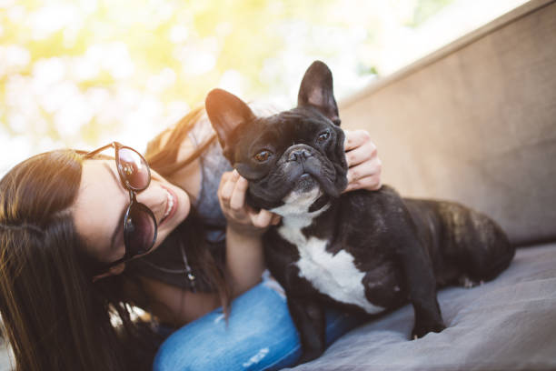Teenage girl with dog Beautiful teenage girl sitting in cafe restaurant with her adorable French bulldog puppy. People and dogs theme. pics of a tapeworm in humans stock pictures, royalty-free photos & images