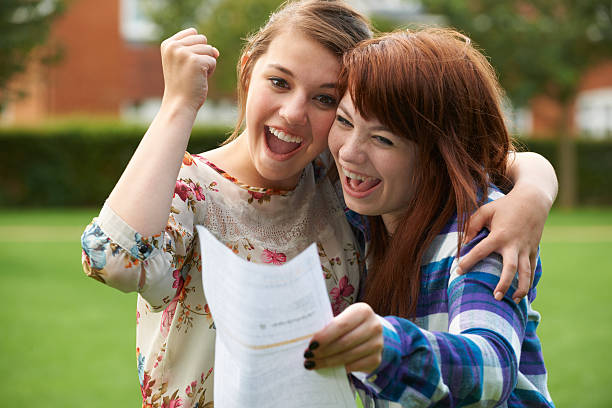 Teenage Girls Celebrating Good Exam Result First steps on road to a successful career students exam results stock pictures, royalty-free photos & images