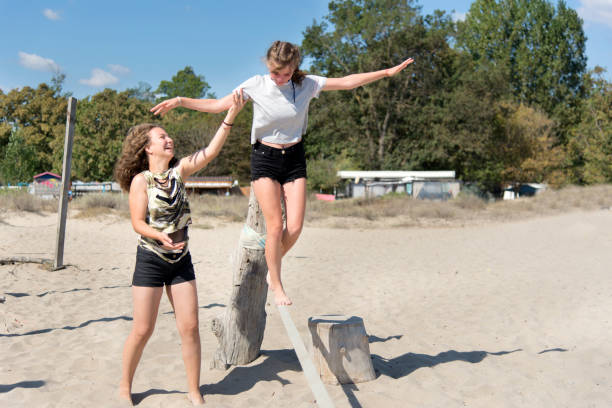 Teenage girls having fun on the beach stock photo