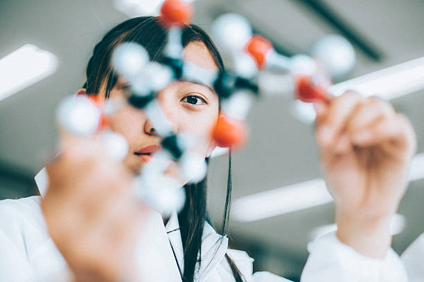 Teenage Student in Chemistry Lab Japanese High School Girl holding a glucose molecular model in the chemistry lab molecular structure stock pictures, royalty-free photos & images