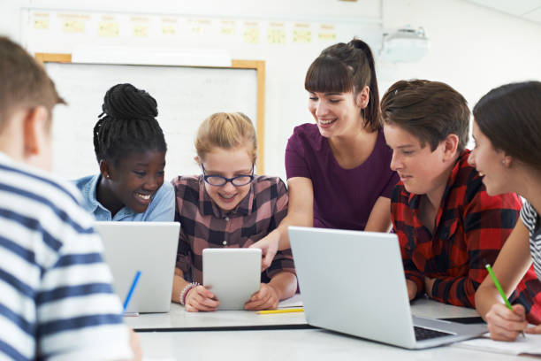 Teenage Students With Teacher In IT Class stock photo