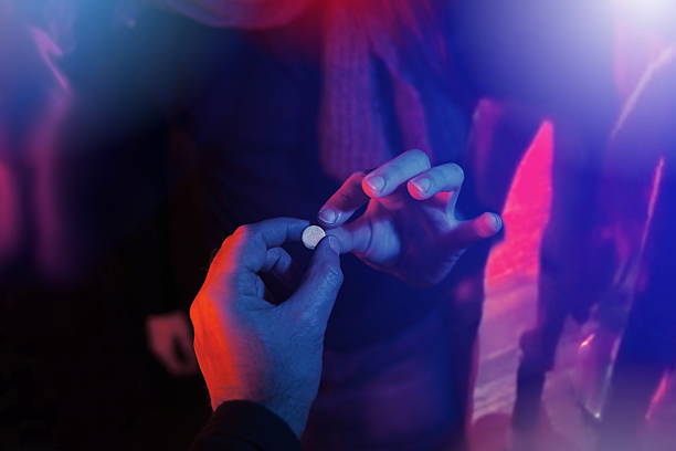 teenager buying drug at club teenager buying drug at club during spring break party recreational drug stock pictures, royalty-free photos & images