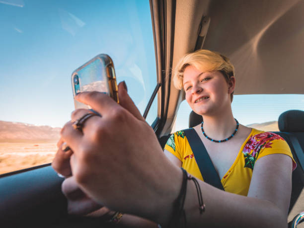 Teenager Enjoying Family Road Trip Taking Selfie stock photo