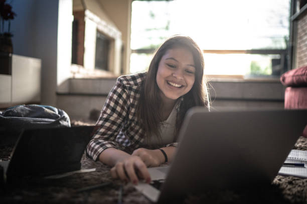 Teenager girl studying at home on a laptop at home Teenager girl studying at home on a laptop latina girl stock pictures, royalty-free photos & images