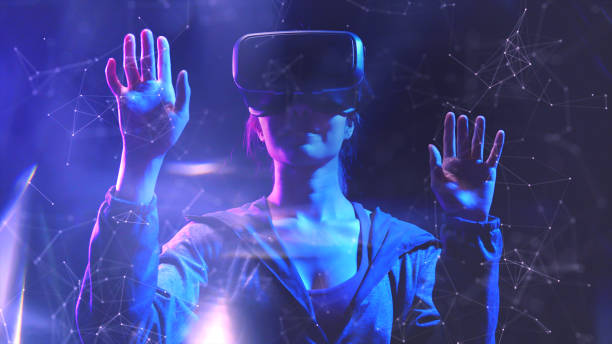 Teenager having fun play VR virtual reality glasses sport game 3D cyber space futuristic neon colorful background, future digital technology game and entertainment stock photo