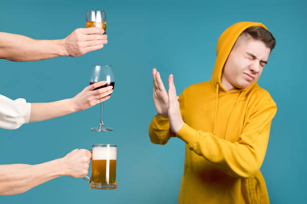 man refusing alcohol from three people