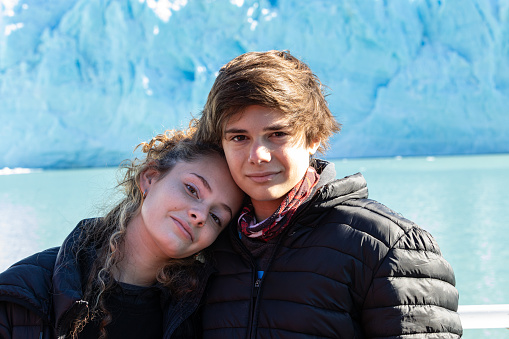 16-17 girl and 14-15 boy hugging and posing at Glaciar Perito Moreno