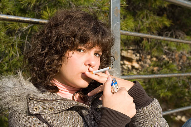 teenager smoking young teenage girl smoking a cigarette little girl smoking cigarette stock pictures, royalty-free photos & images