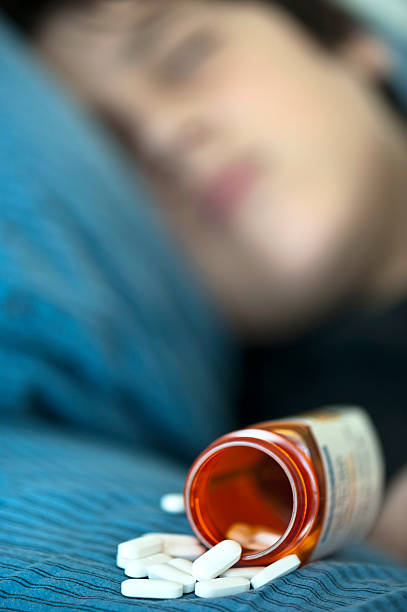 Teenager taking prescription drugs  xanax pills stock pictures, royalty-free photos & images