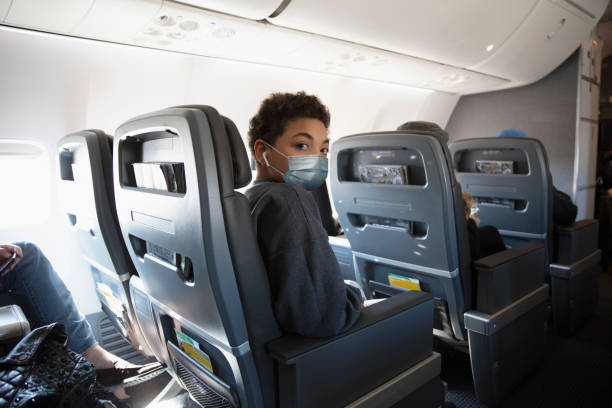 Teenager traveling with face masks for COVID-19 stock photo