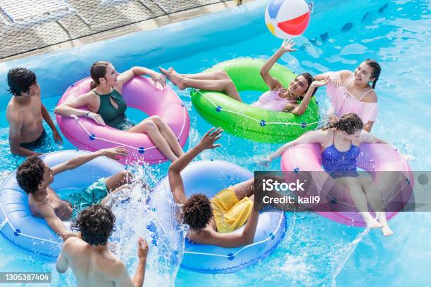 Teenagers at water park playing in lazy river