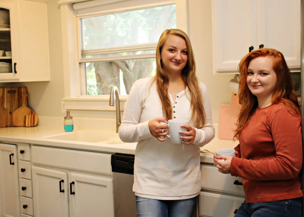 Teenagers Chatting in the kitchen stock photo
