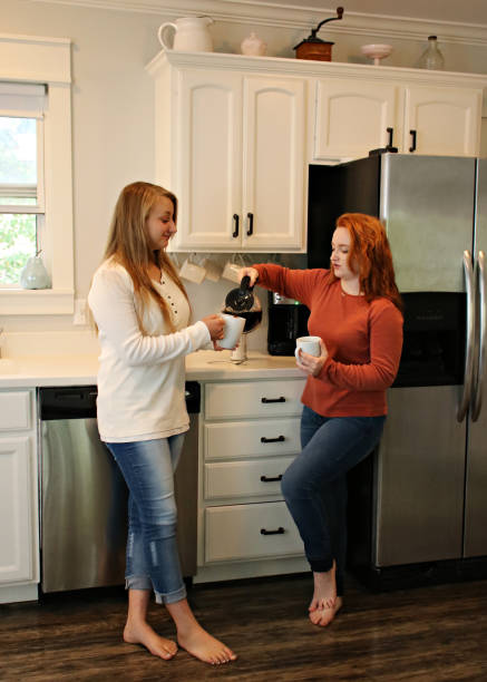 Teenagers Chatting in the kitchen stock photo