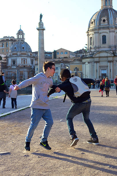 Teenagers dancing near Trajan's Column. stock photo