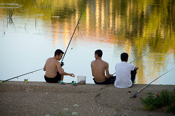 Teenagers fishing stock photo