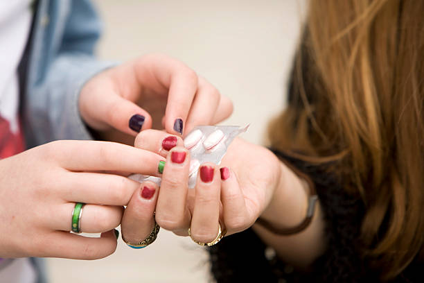 Teens with pills Teenage girls with a packet of pills yt stock pictures, royalty-free photos & images