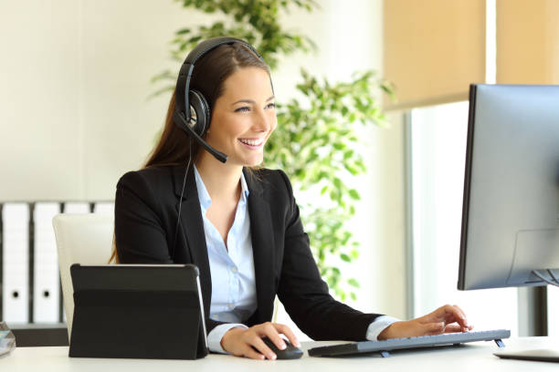 Tele marketer working at office with computer Tele marketer working at office with computer headset woman customer service stock pictures, royalty-free photos & images