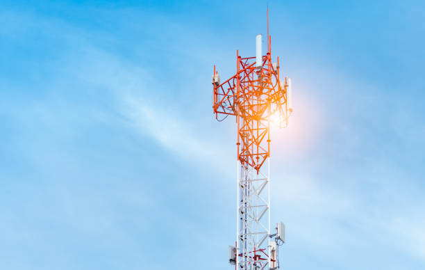 Telecommunication tower with blue sky and white clouds background. Antenna on blue sky. Radio and satellite pole. Communication technology. Telecommunication industry. Mobile or telecom 4g network. stock photo
